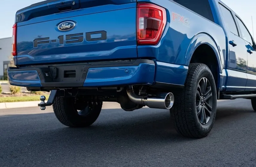 Stainless steel exhaust muffler and tip installed under vehicle — under $500 exhaust fitment
