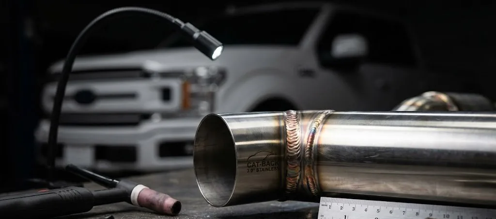 Cat-back exhaust pipe with welded seams on a workbench