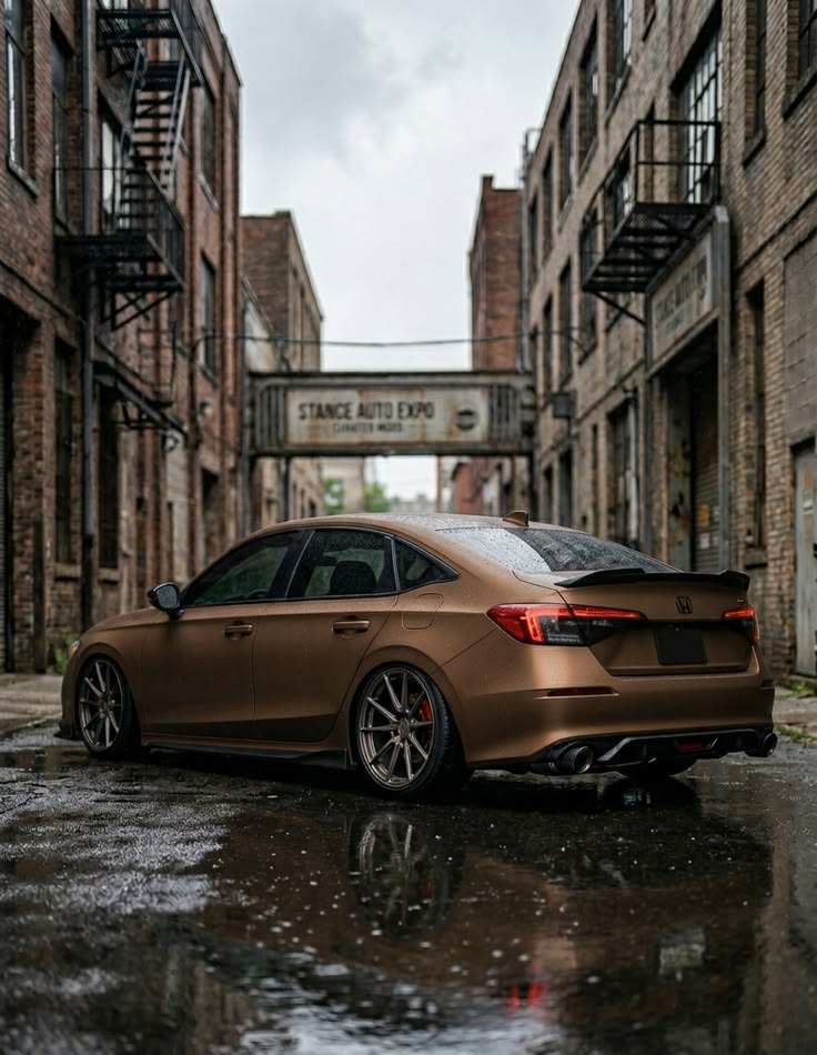 Bronze matte Honda Civic sedan modified with lowered suspension in urban alley