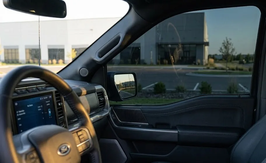 Interior view from inside Ford F-150 looking through tinted side window showing visibility and tint effect