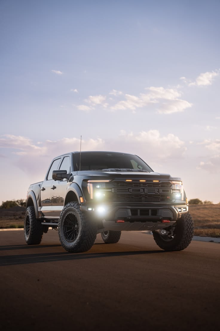 Ford F150 Raptor R with bright LED headlights at dusk in Texas