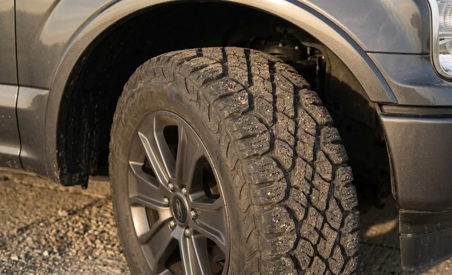 Close-up of a dusty all-terrain tire on a Ford F150